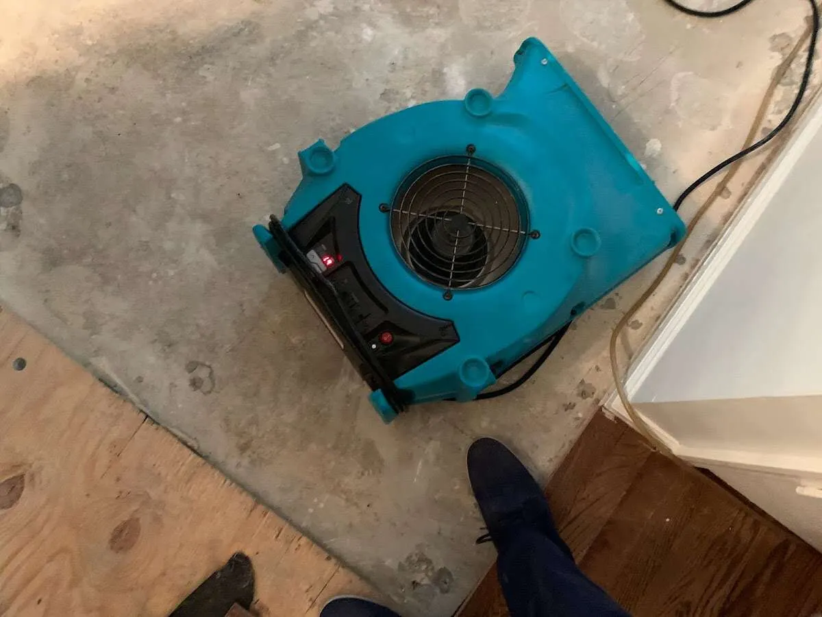 Air mover drying subfloor during Leak Detection & Repair in White Rock